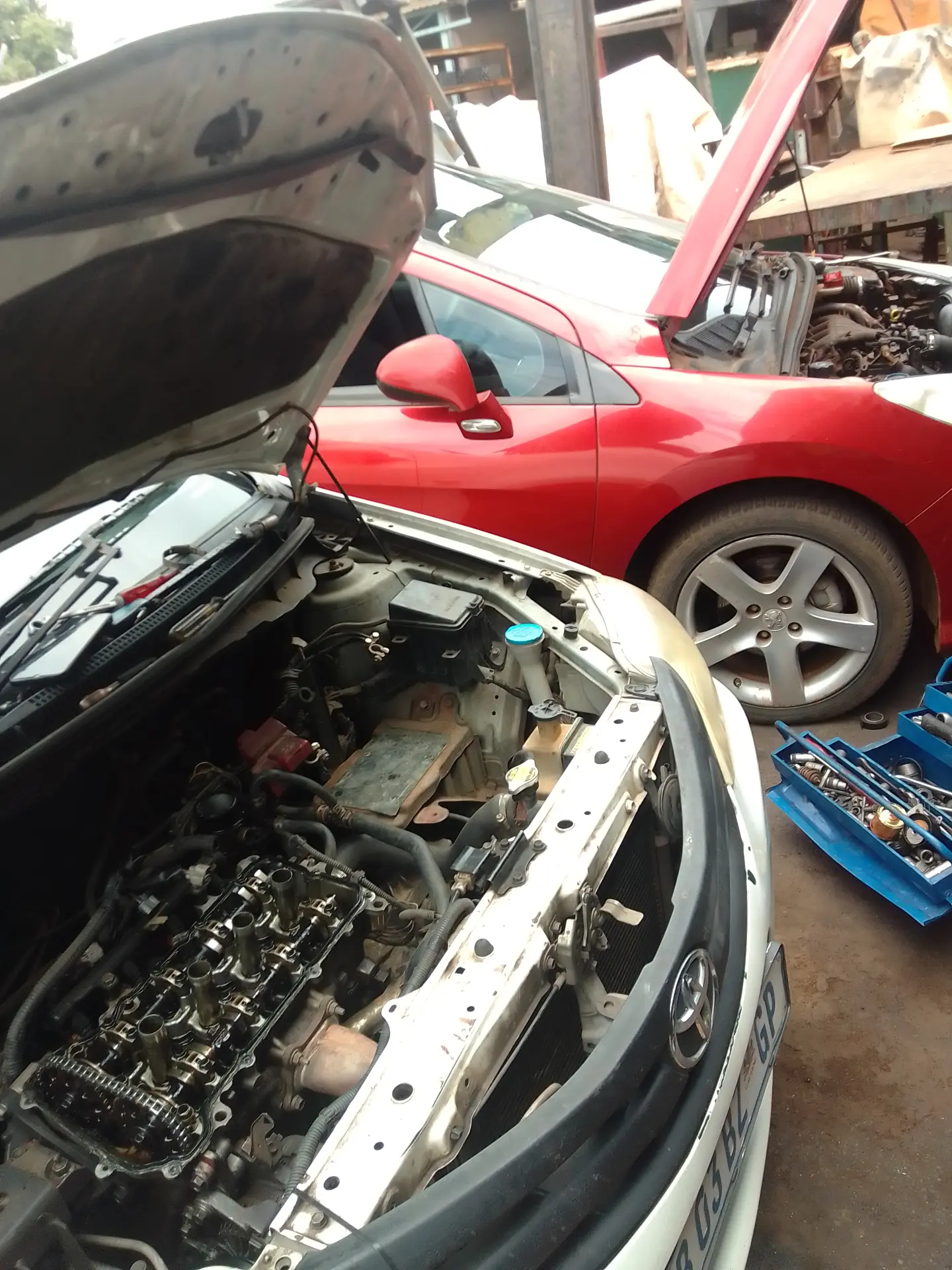 Vehicles with open bonnets in the Auto Clinic workshop